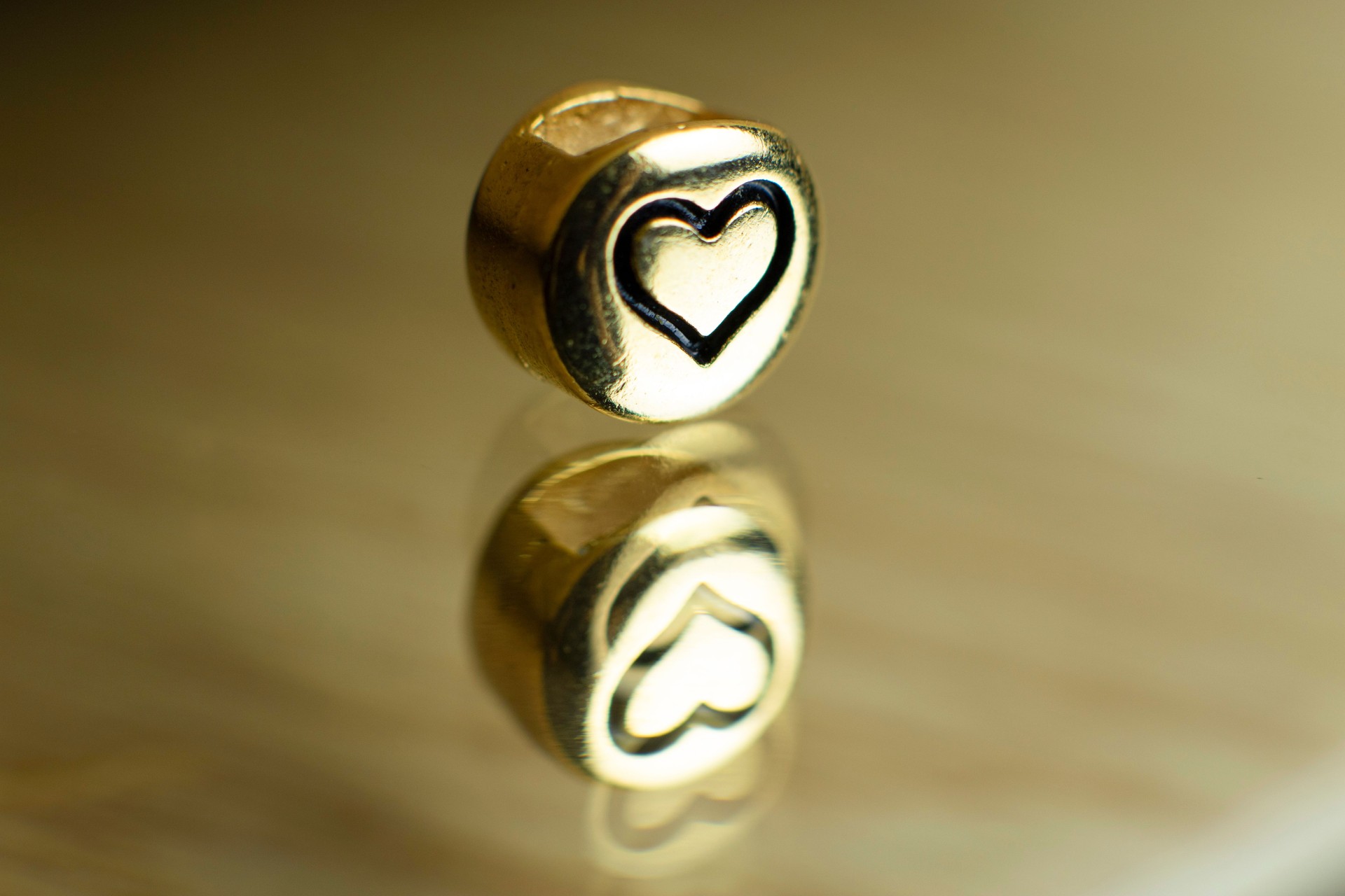 Gold metal with heart design, reflection