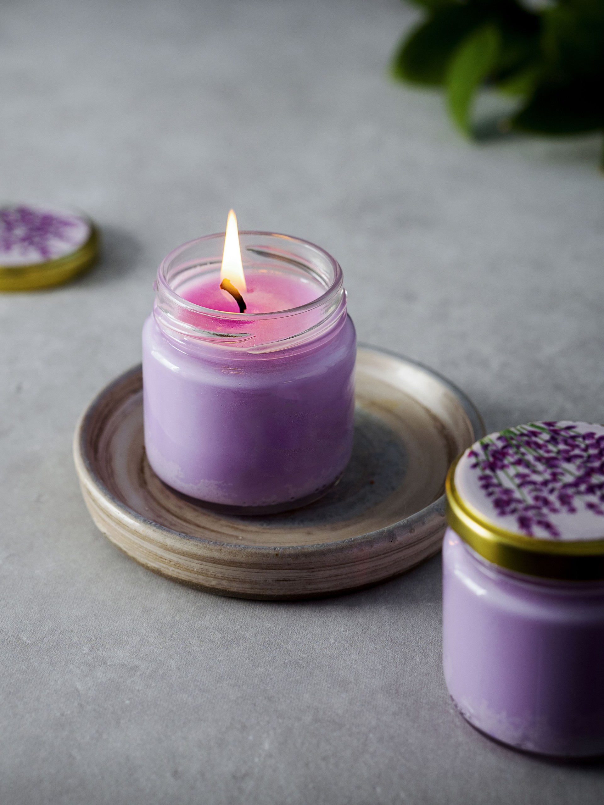 Lavender Candle (close-up shot) with dried plants on bright background
